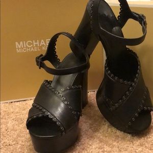 Scalloped and grommetted leather and lace heels